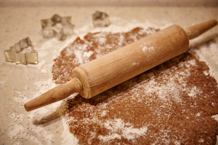 A dough and a rolling pin in the kitchenの写真素材