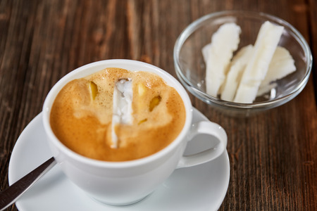 Coffee, butter and coconut oil for bulletproof coffee on a brown wooden tableの写真素材