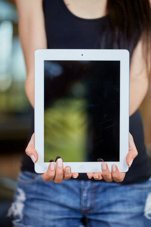 Young caucasian woman holding tabletの写真素材