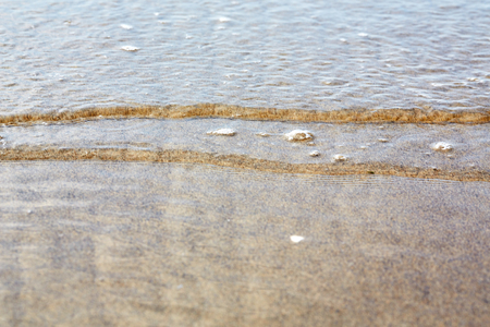 Little ripples in the sand from the sea on the beachの写真素材