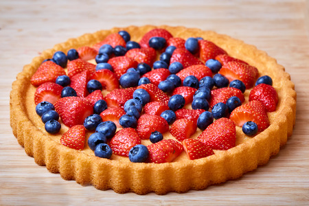 Dessert biscuit with strawberries and blackberries on a tableの写真素材