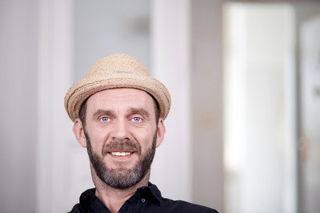 Portrait of friendly looking hipster with stray hat high key shotの写真素材
