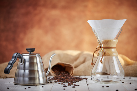 Brewign third wave coffee with chemex glass and drip kettle for pure flavor in good design on wooden tableの写真素材