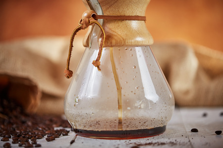 Brewign third wave coffee with chemex glass and drip kettle for pure flavor in good design on wooden...