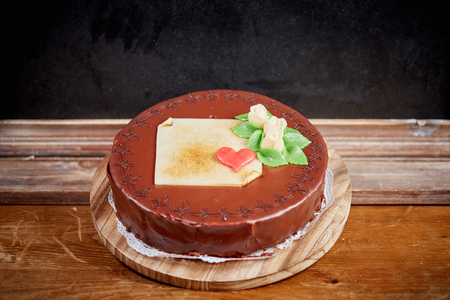 Sacher chocolate cake for birhtday on brown wooden tableの写真素材