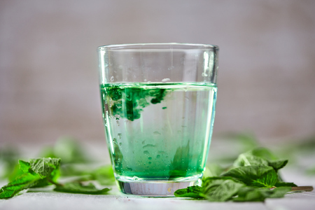 Chlorophyll detox drink with green mint on white tableの写真素材