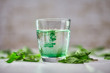 Chlorophyll detox drink with green mint on white tableの写真素材
