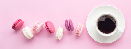 Colorful cake macaron or macaroon isolated over pastel pink background. Top view.の写真素材