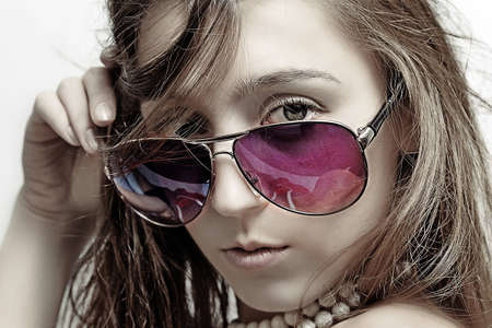 The girl in sun glasses and  beadsの写真素材