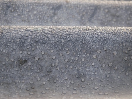 Dew drops on zinc close up background and texture abstractの素材