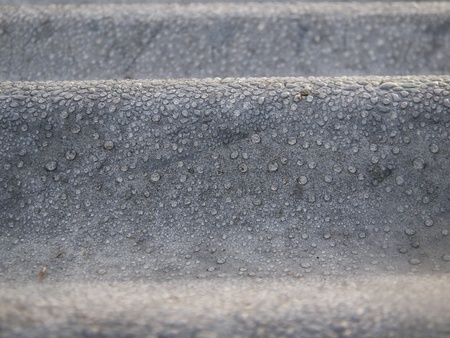 Dew drops on zinc close up background and texture abstractの素材