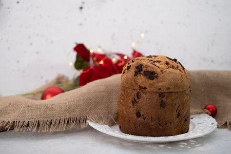 Warm atmosphere with chocolate chips panettone and lightsの写真素材
