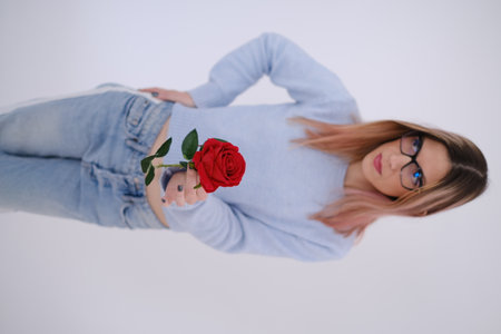 Young attractive woman holding and giving away a rose. Love concept. Self loveの写真素材
