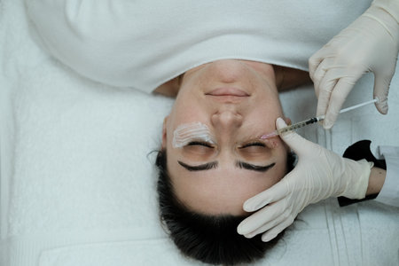 Top view of female patient having eye mesotheraphy applied