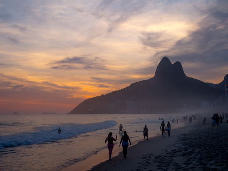RIO DE JANEIRO, BRAZIL - OCTOBER 24, 2016:  People enjoy the Ipanema Beach at Sunset in Rio de Janeiroのeditorial素材