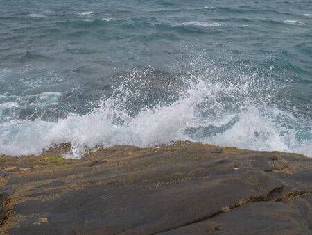 Waves Splashes on the rocksの写真素材
