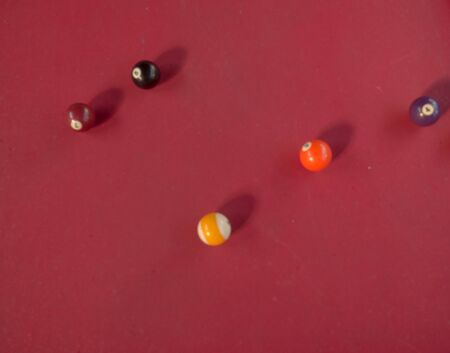 Pool balls on a red table