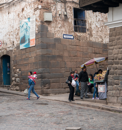 CUZCO, PERU - NOVEMBER10, 2016: Unidentified people walk down cobbled street near Plaza de Armas in Cuzco, Peru, November 10, 2016. Cuzco is UNESCO World Heritage Site and famous for its historical areas.のeditorial素材