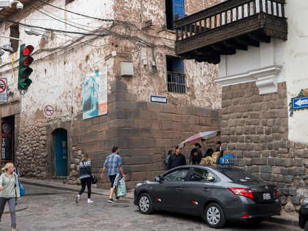 CUZCO, PERU - NOVEMBER10, 2016: Unidentified people walk down cobbled street near Plaza de Armas in Cuzco, Peru, November 10, 2016. Cuzco is UNESCO World Heritage Site and famous for its historical areas.のeditorial素材