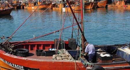 BUENOS AIRES, ARGENTINA - JANUARY 02, 2015:  A fisher men works at the por of Mar del Plata, in Buenos Aires, Argentinaのeditorial素材