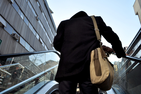Man getting out of the subway stairsの写真素材