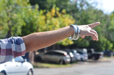 Woman hand pointing outdoorsの写真素材