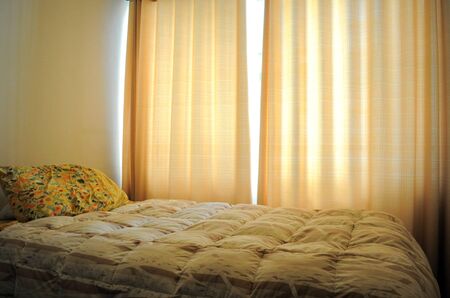 bedroom interior with yellow courtainsの写真素材