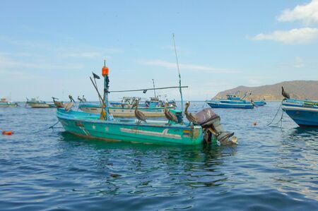 PUERTO LOPEZ, ECUADOR - MARCH 20, 2016:  Pelicans on a fishing boat are seen in the port of Puerto Lopez in Manabi Province, Ecuadorのeditorial素材