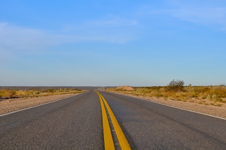 Close up asphalt with yellow lines at La Pampa dessert in Patagonia, Argentinaの写真素材