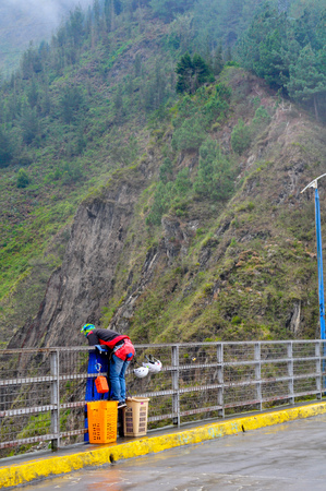 BANOS, ECUADOR - MARCH 25, 2016:  Unidentified people at bridge jumping (puenting) on San Francisco Bridge on March 25, 2016 in Banos, Ecuador.のeditorial素材
