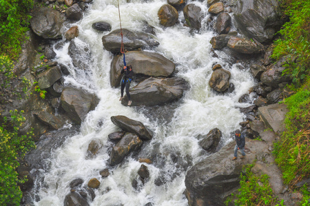 BANOS, ECUADOR - MARCH 25, 2016:  Unidentified people at bridge jumping (puenting) on San Francisco Bridge on February 26, 2014 in Banos, Ecuador.のeditorial素材