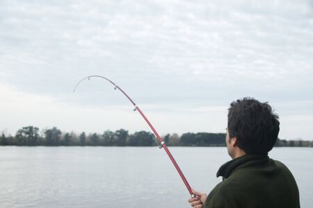  Young man fishing in a pond  