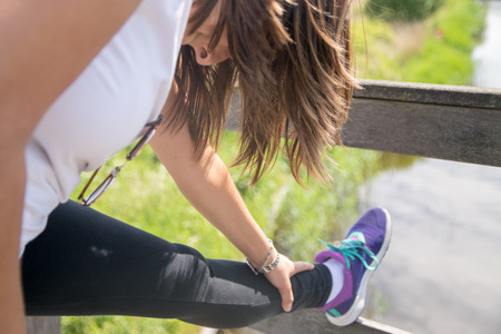 Woman stretching outdoors against river