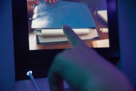 MADRID, SPAIN - JUNE 18, 2017:  Hand touching a digital screen during a travel in the airplaneのeditorial素材