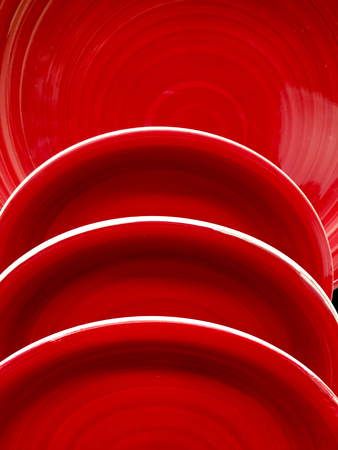 Stack of red ceramic plate dishesの写真素材