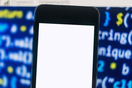 Smart phone isolated screen against programming codeの写真素材