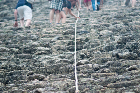 Tourist climb the Pyramid Nohoch Mul at the ruins of the Mayan city Coba