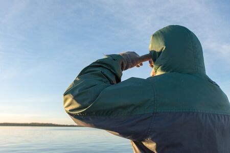 Young Adult Man Outdoors Staring the Horizon with River in Background