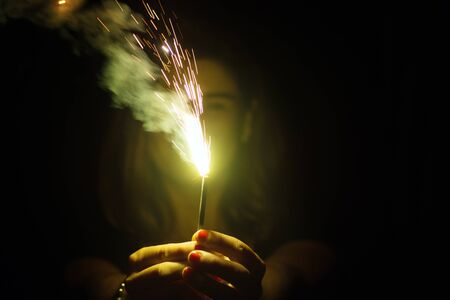 Woman Holding Green Burning Sparklers