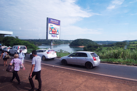 Ciudad Del Este, Paraguay - November 24, 2019: People and Cars Crossing The Friendship Bridge (Spanish: Puente de la Amistad, Portuguese: Ponte da Amizade) is an arch bridge connecting the Brazilian city of Foz do Iguaçu and the Paraguayan city of Ciudad のeditorial素材