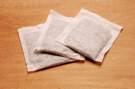 Tea Bags against wooden backgroundの写真素材