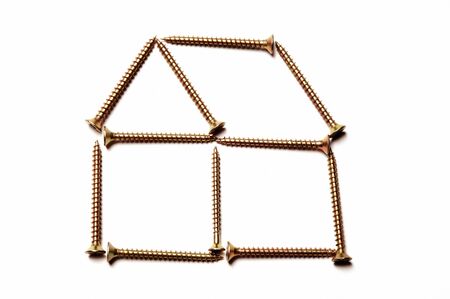 Screws depicting a house on white backgroundの写真素材