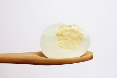 Half Egg on spoon  on white backgroundの写真素材