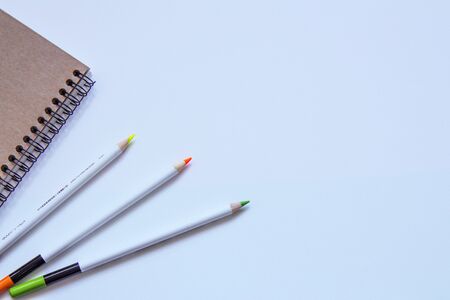 Set of stationery items on white background. Notebook and pencils. Flat lay