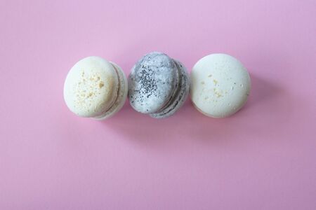 Macarons on a pink background. Beautiful dessert. Flat layの写真素材