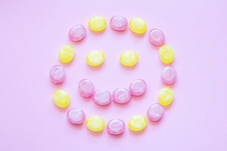 Multicolored candy on a colored background. Flat lay
