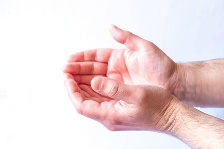 Beautiful men's hands on a white background. Side view