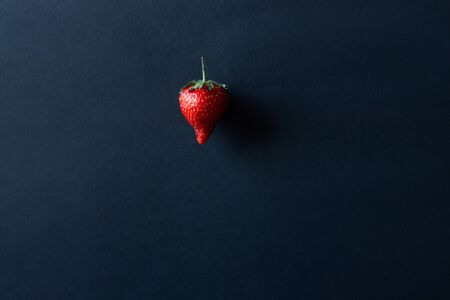 Ripe strawberries on a black background. Dark food photography. Selective focus. Side viewの写真素材