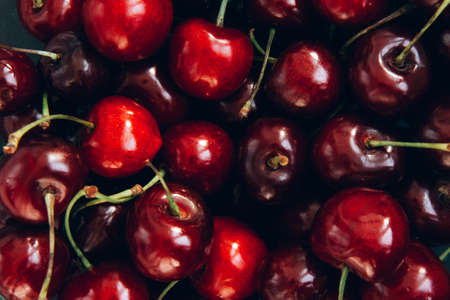 Background of ripe bright red cherries. Close-up of cherries. Summer background. Light and quick breakfastの写真素材