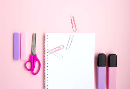 School stationery and supplies on a pink background with space for caption. Back to school, homeschool creative workspace. Minimalistic set of colorful stationery. Flat layの写真素材